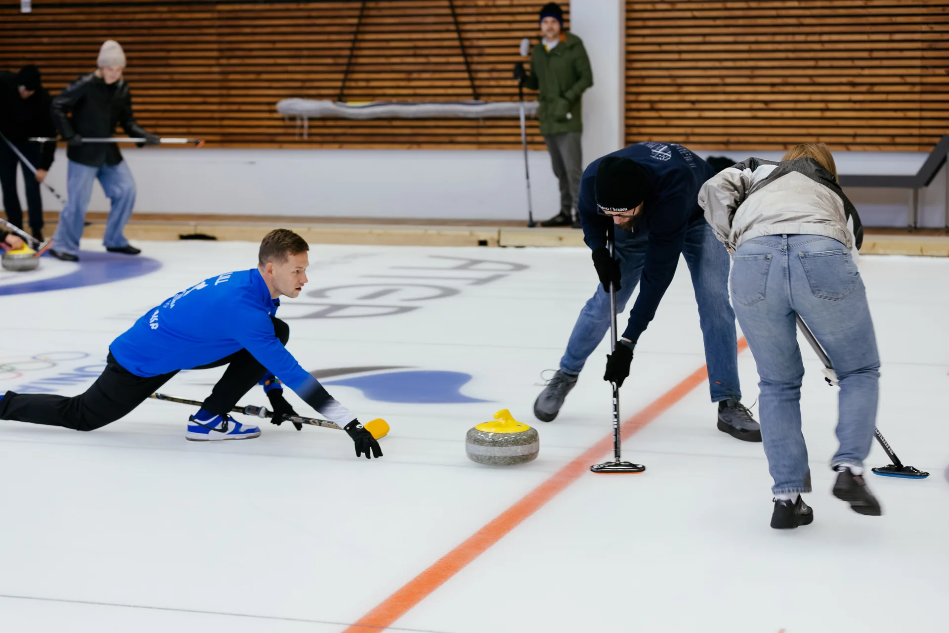 A ParkBee team member releasing a curling stone during the matches