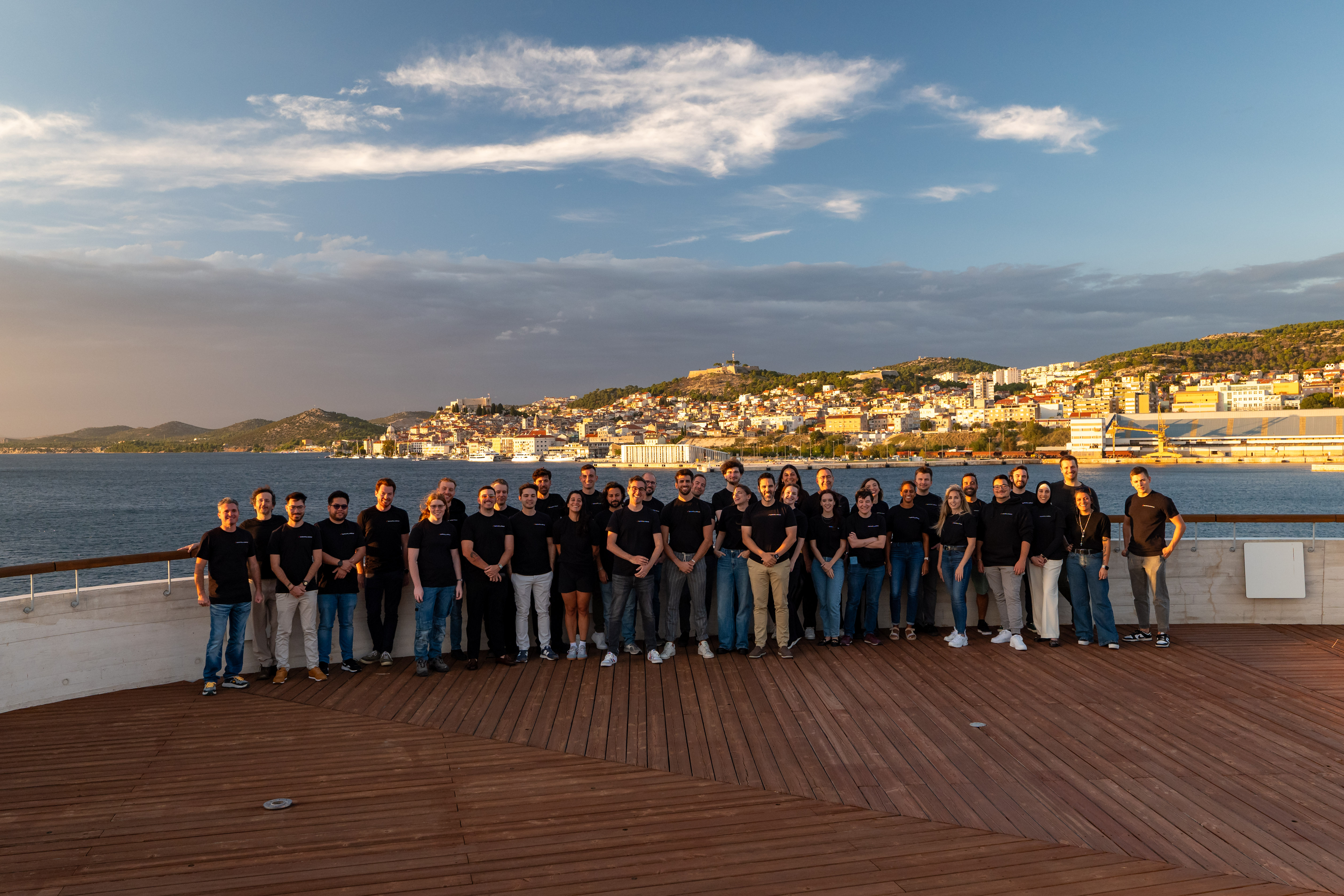 Colleagues meeting in person for the first time at a remote company retreat.
