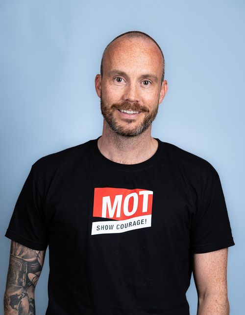 mann smiler til kamera