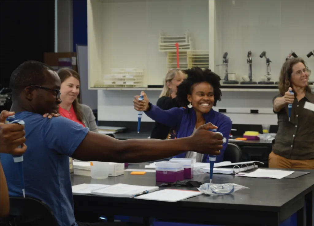Students learning how to use a micropipette