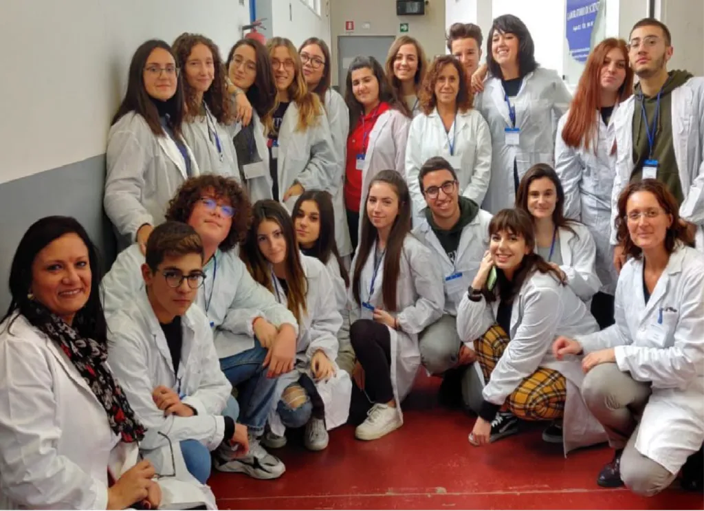 Paola Travascio and her students at Pitagora High School in Pozzuoli, Italy.||22 teachers and students from Pitagora High School in Pozzuoli, Italy, pose for a group photograph in the hallway of their school.|