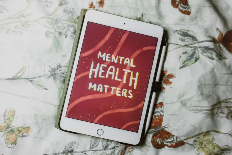An iPad displays the text "Mental health matters."