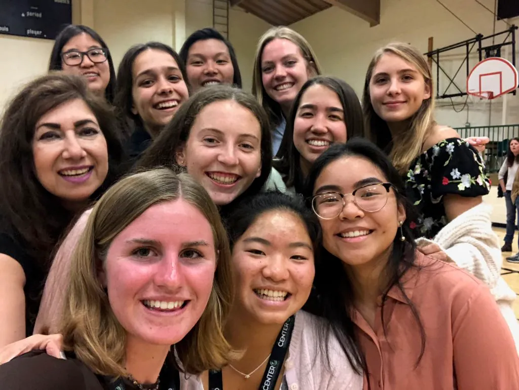Educator Nikki Malhotra poses for a group photo with ten female students at Thousand Oaks High School.