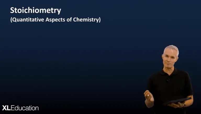 A screenshot from a video presentation showing a man in the lower right corner, with the text "Stoichiometry (Quantitative Aspects of Chemistry)" in the upper left.