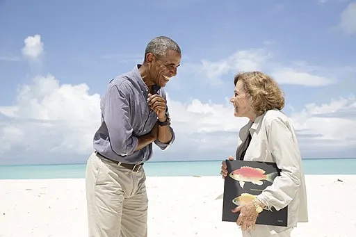 President Barack Obama talks with oceanographer Dr. Sylvia Earle, National Geographic Society Explorer-in-Residence during a visit to Midway Atoll, Sept. 1, 2016. Dr. Earle shows the President a photo of a newly discovered species of blue fish native to Midway waters.