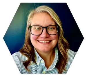 A smiling woman (Jenny Frank) with long, blond hair, and glasses.