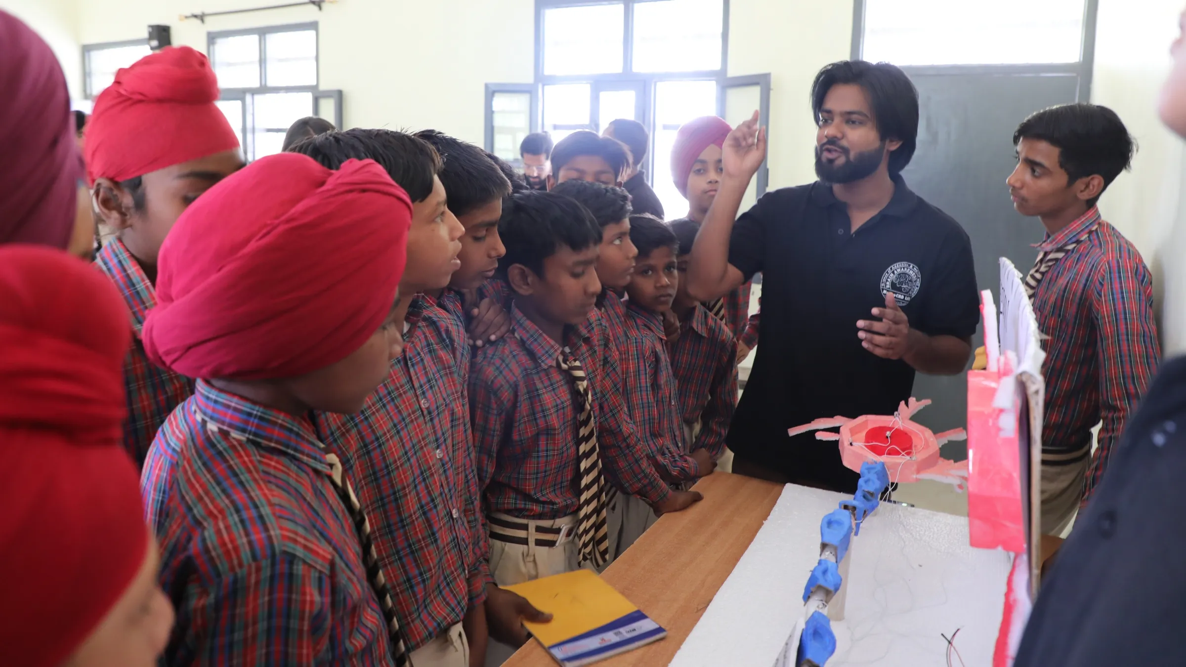 Students observe a model of a neuron at a school in India. Photo by Suryanarayan Biswal.
