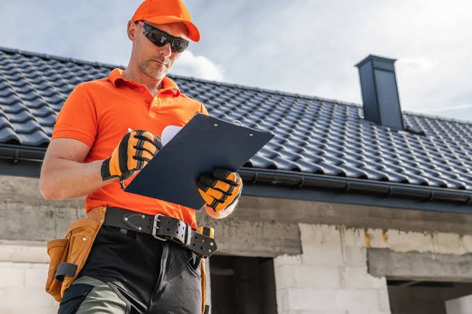 Roofing professionals working on a residential property