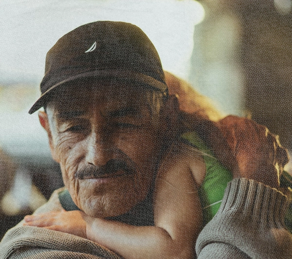 An older man holding a child