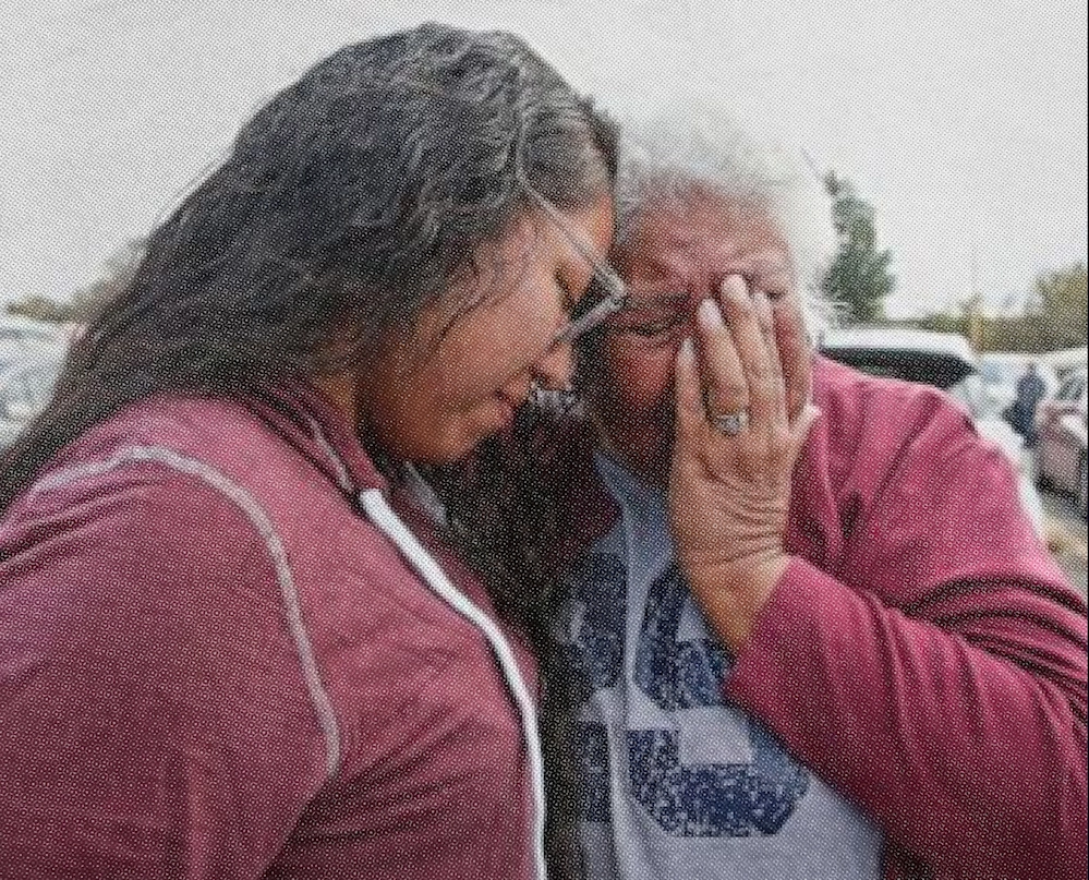 Two people hugging and crying
