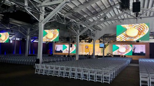 A corporate event with our stage, drape, AV and lighting design.