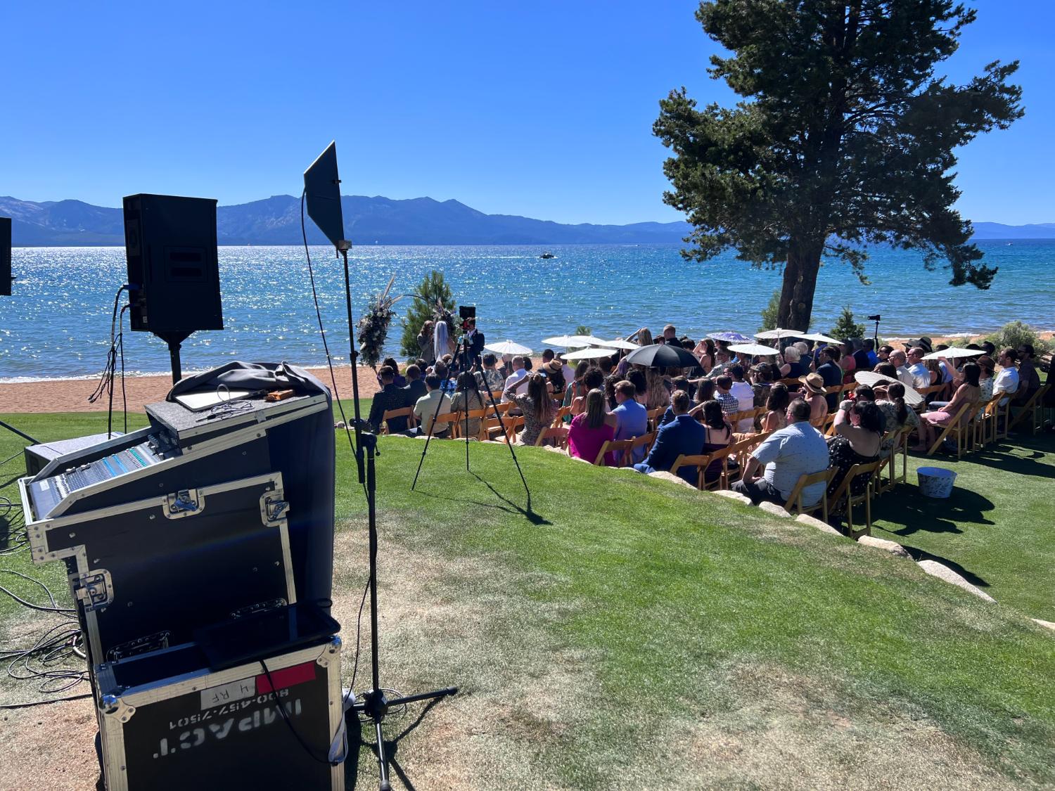 Audio console mixing a lakeside event by Impact