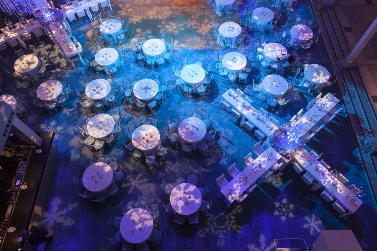 A gala under a deep blue chandelier installation at Chase Center