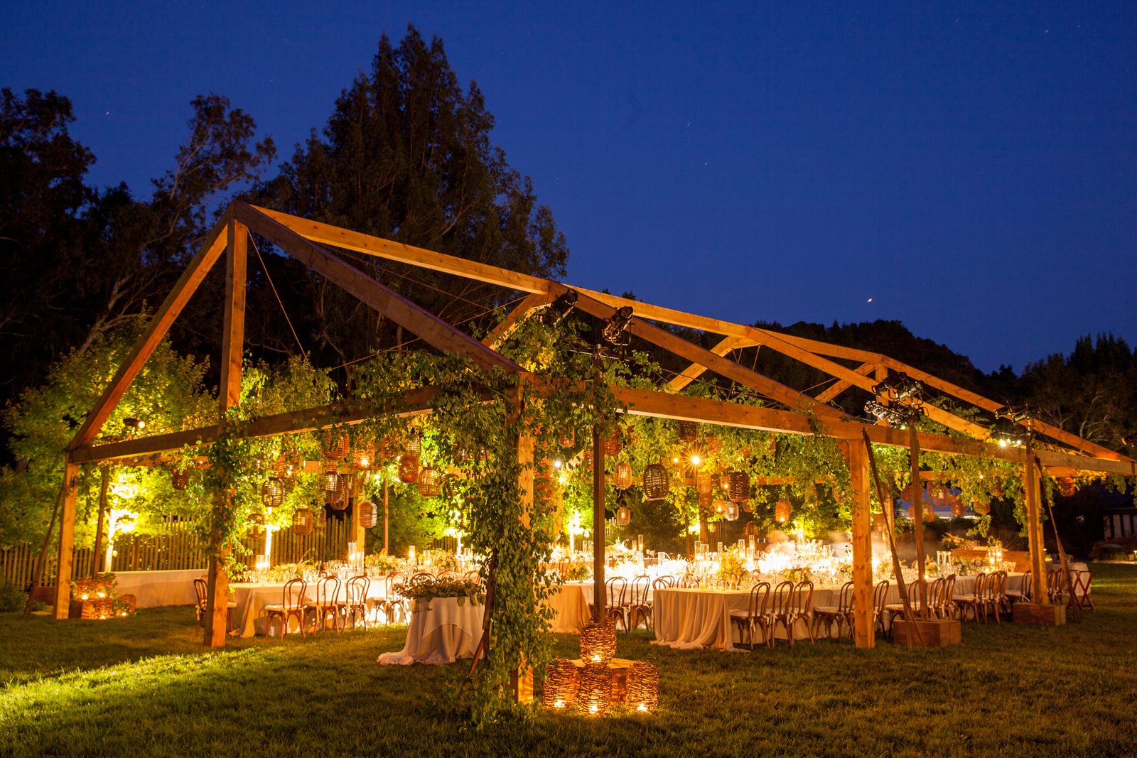 Tented garden reception structure with string lighting by Impact