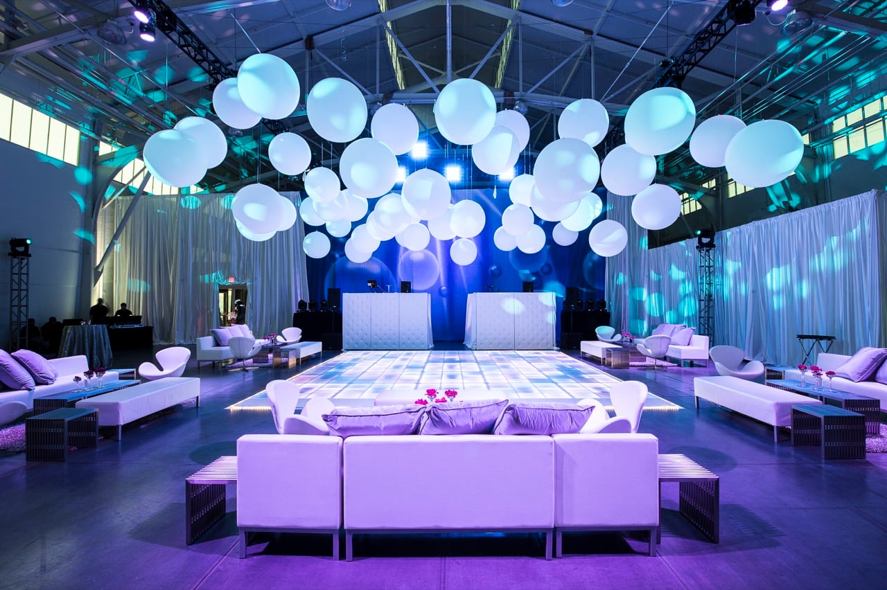 White drape walls, sphere canopy and lit dance floor staged by Impact at Herbst Pavilion