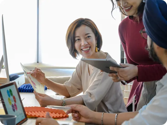 People laughing looking at documents