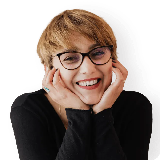 Person smiling resting their head on their hands