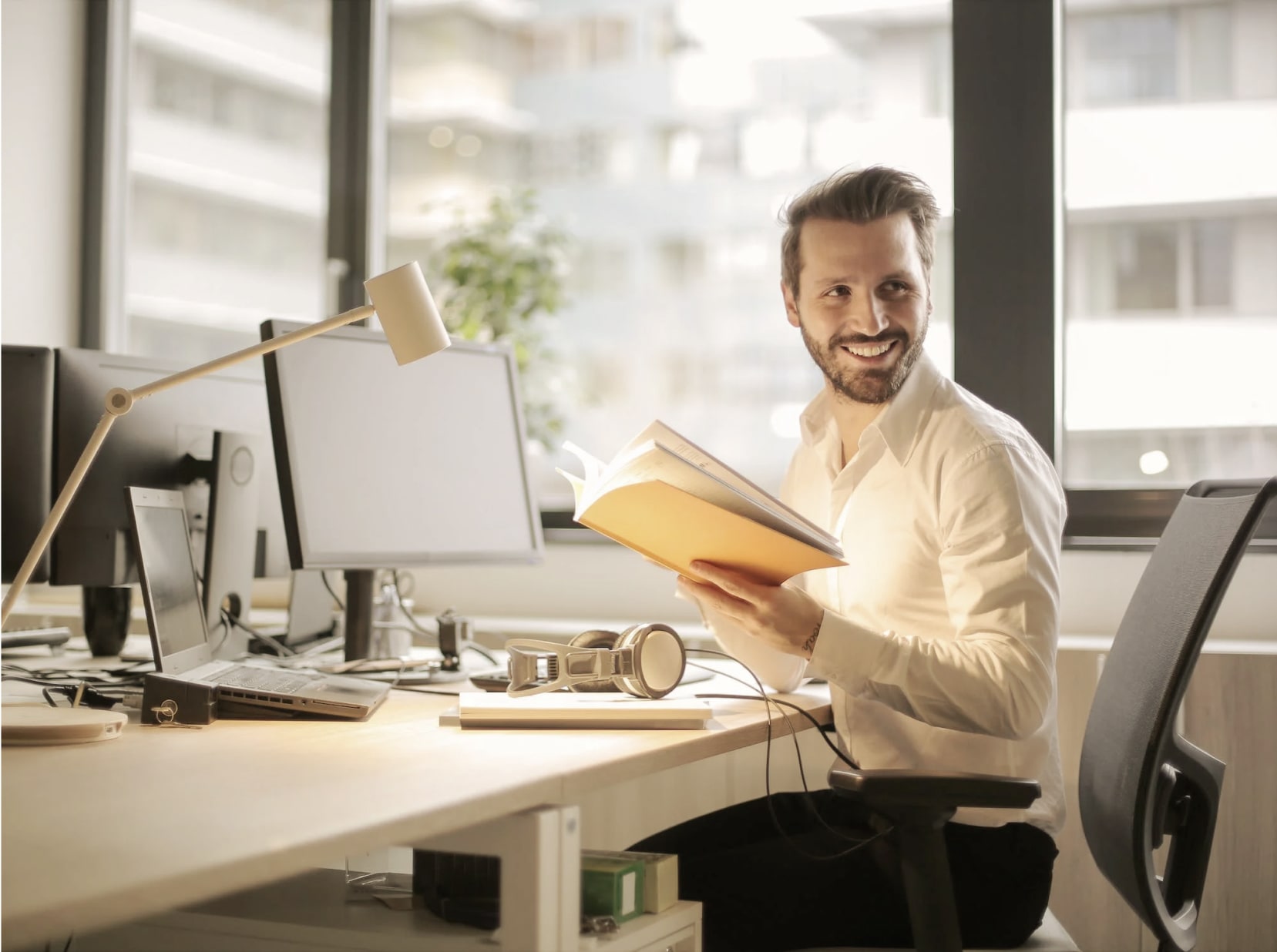 An office worker sits at his computer desk.