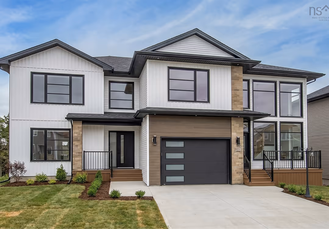 Front exterior of a modern two-storey home with an attached accessory dwelling unit featuring mixed siding, black-trimmed windows, and a landscaped driveway
