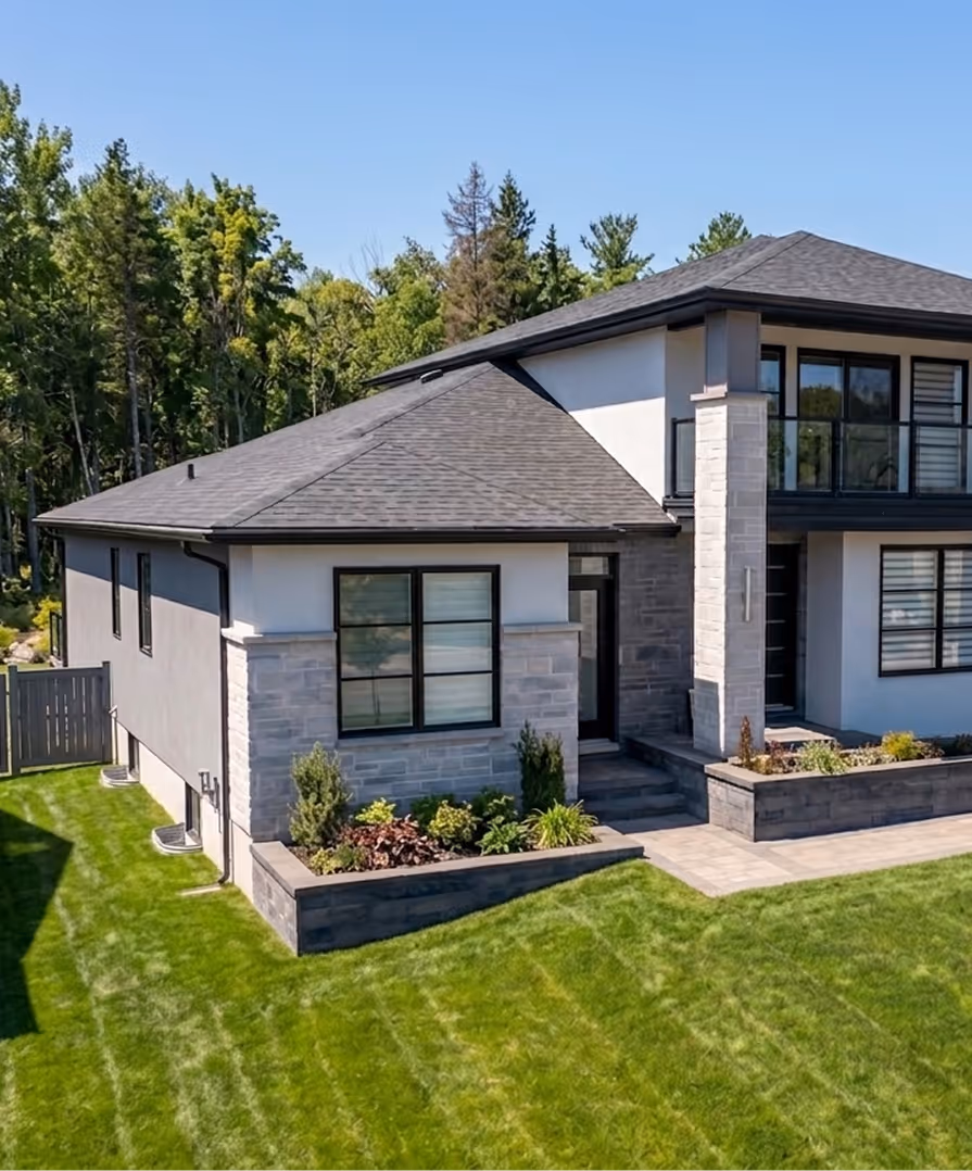 A designer at Signature Home Builders reviewing printed floor plans for a modern ADU specifically designed for the Nova Scotia climate