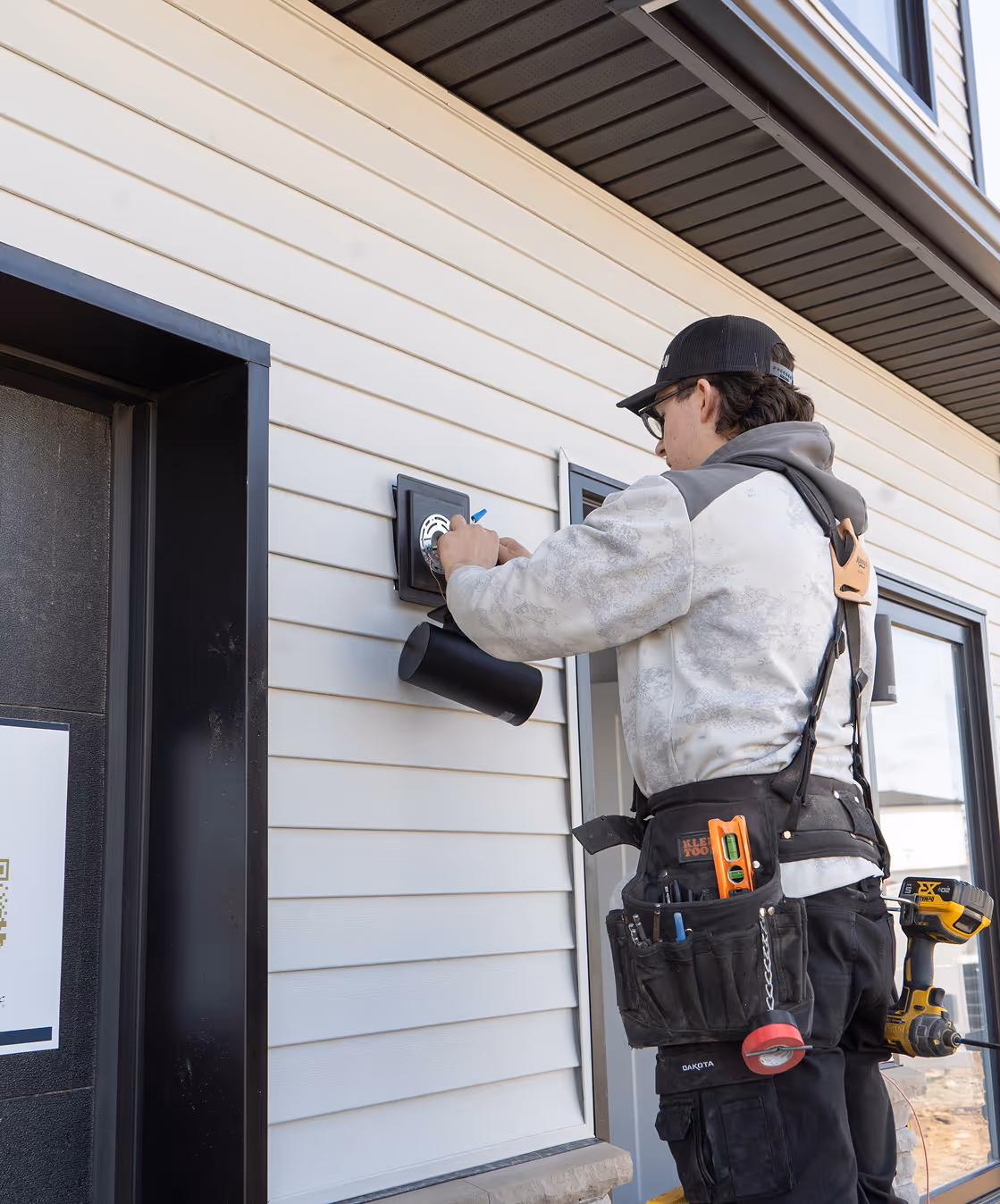 Electrician installing outlets in sustainable home construction for net-zero energy-efficient building in Halifax