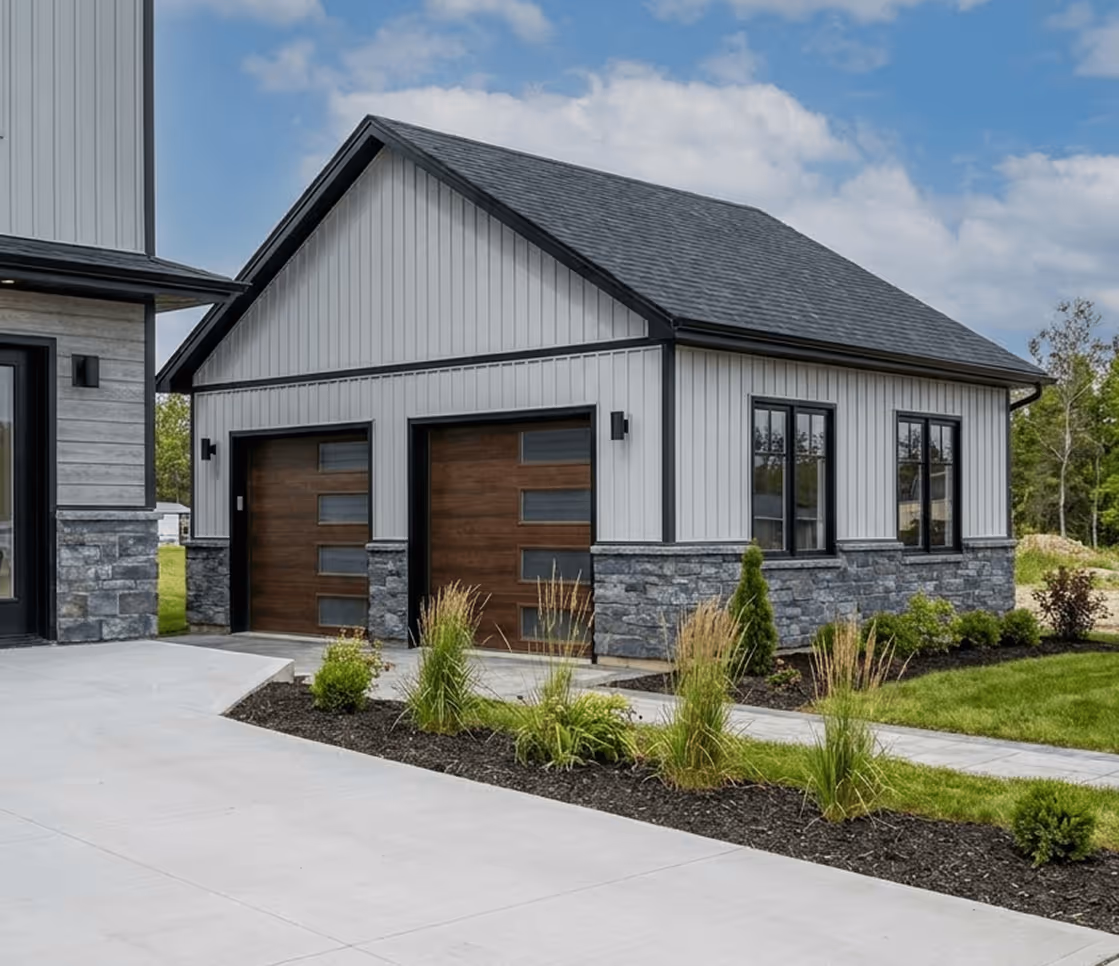 Contemporary custom garage with wooden panel doors, stone facade, and landscaped walkway in Halifax