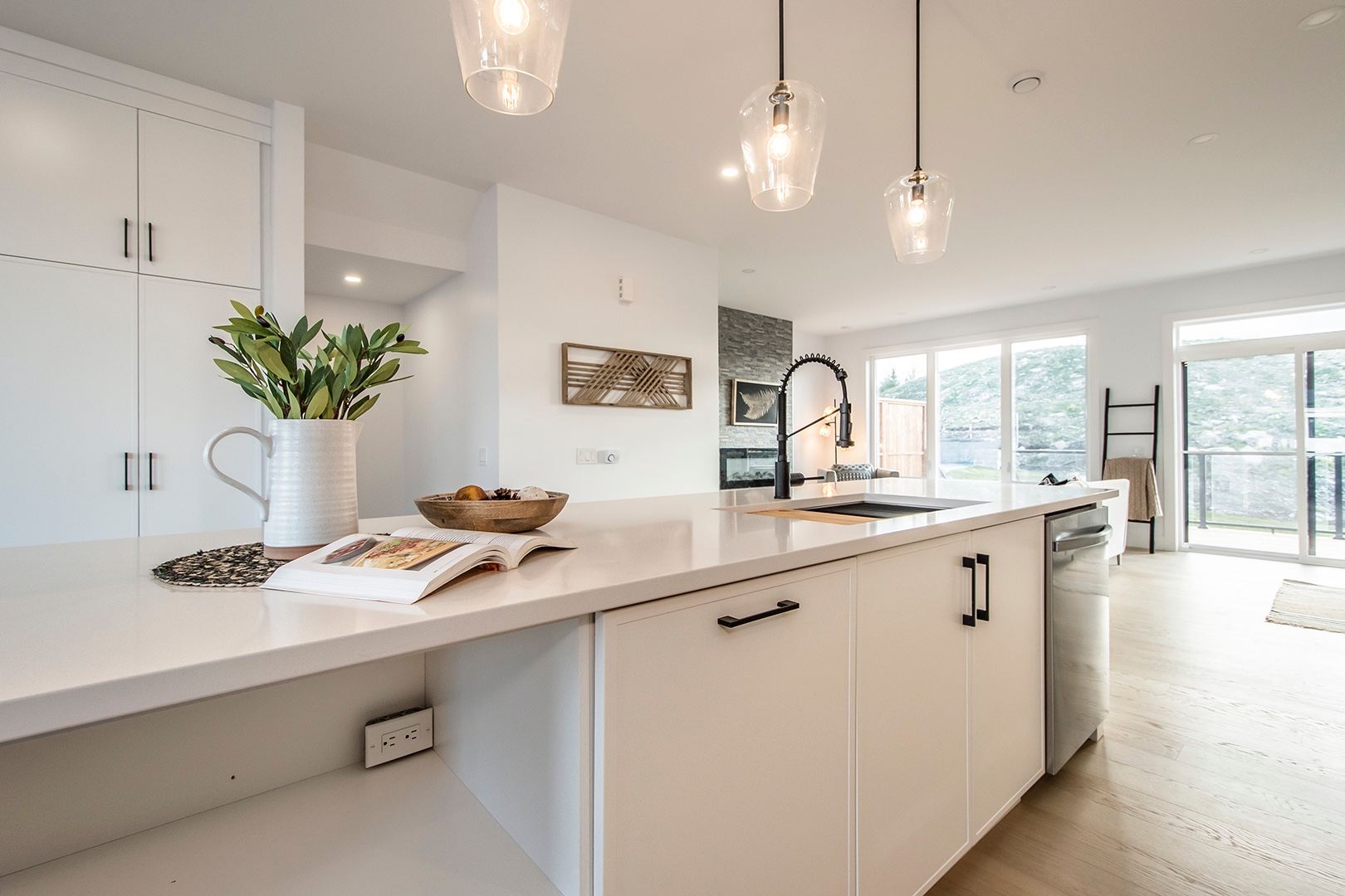 Contemporary kitchen with white cabinetry and pendant lighting showcasing modern home office interior design