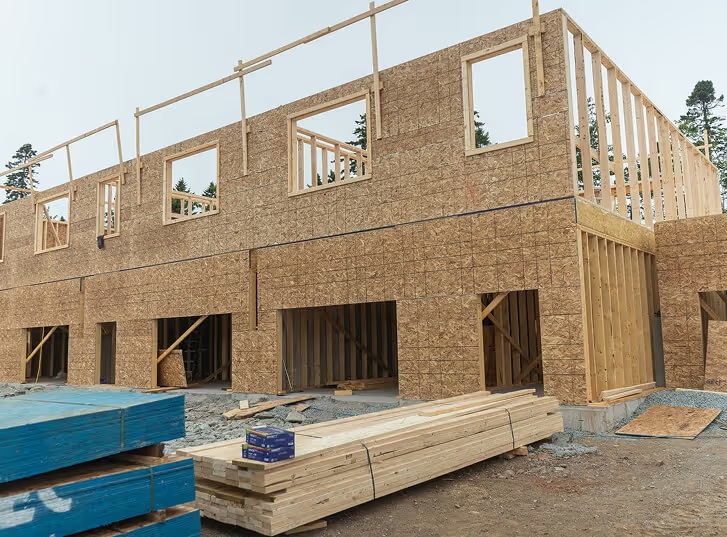Custom home under construction in Halifax showing wooden framing and OSB sheathing for personalized house plans designed around client needs