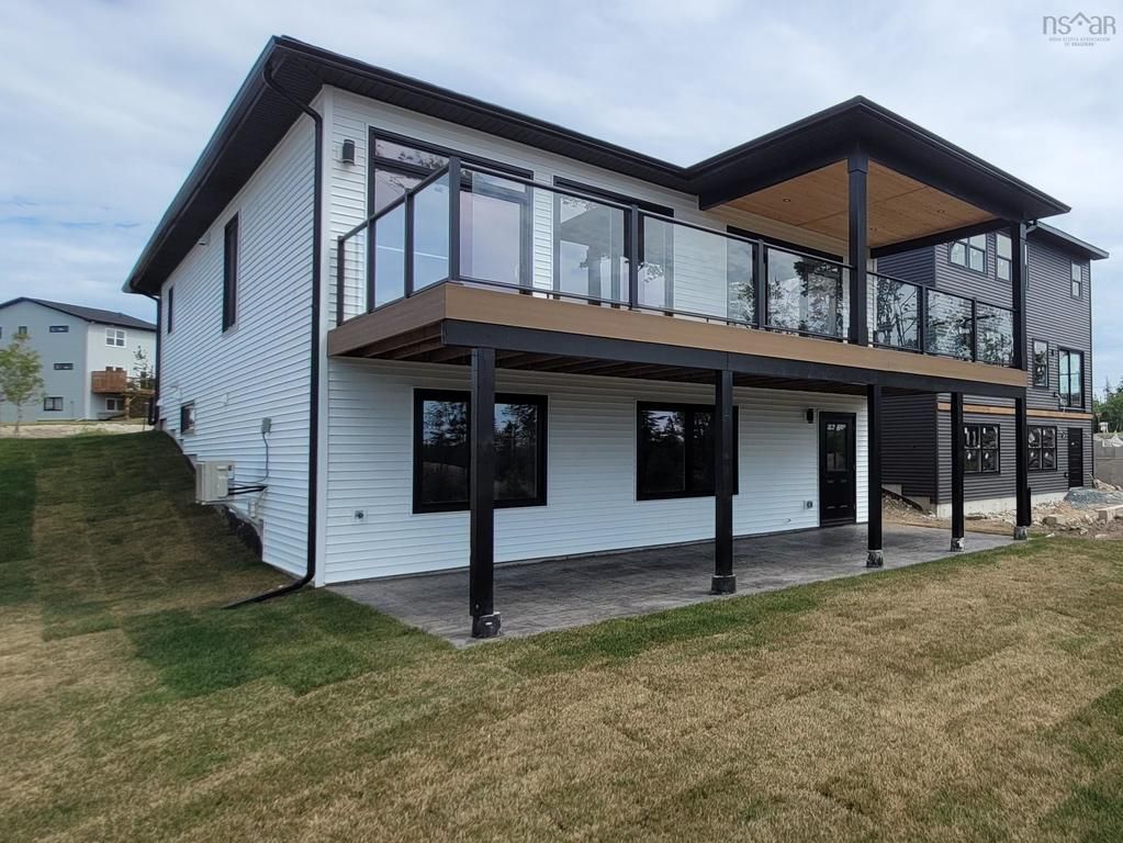 Modern custom built two-story home with elevated deck and glass railings in Halifax - Signature Homes new construction