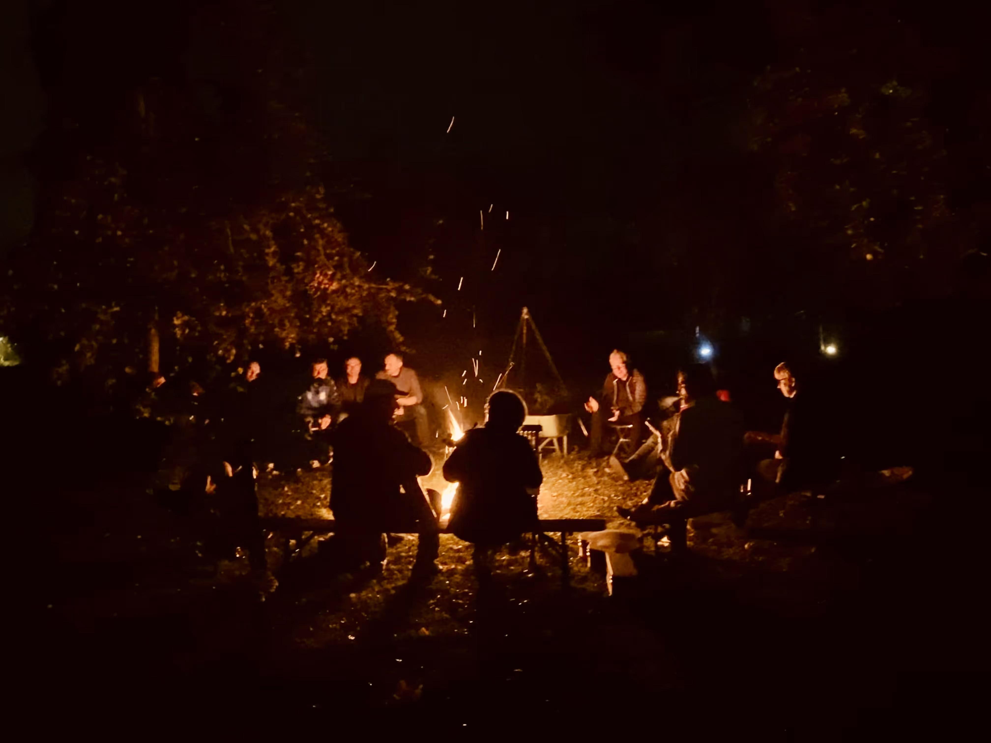 Grupo reunido à volta da fogueira durante a noite na Casa da Seara