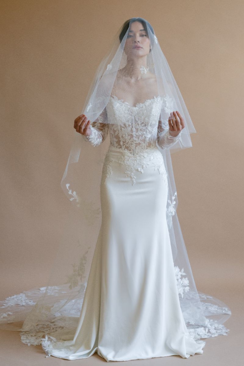 Bride wearing long lace veil 