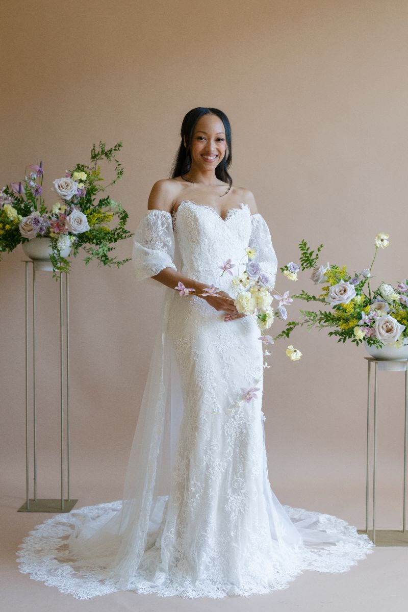 Bride wearing lace trumpet gown with off-the-shoulder tulle sleeves