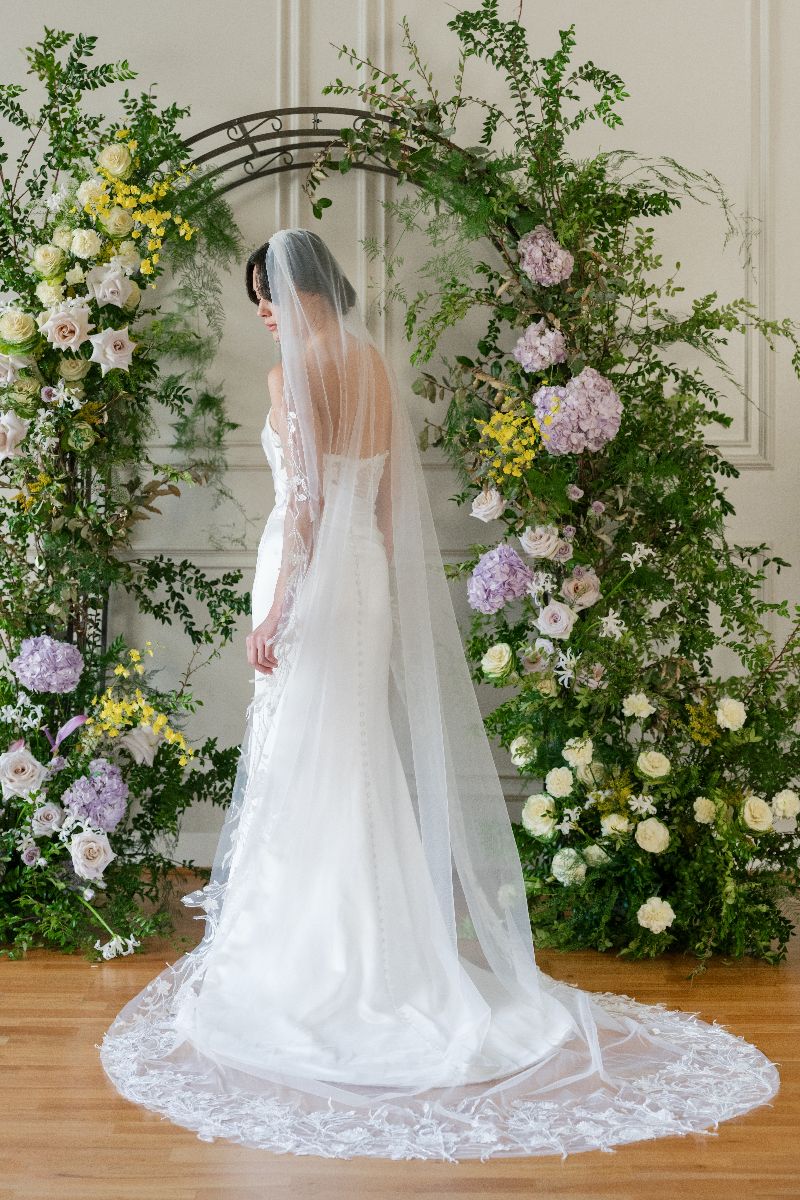 Bride wearing long lace veil 