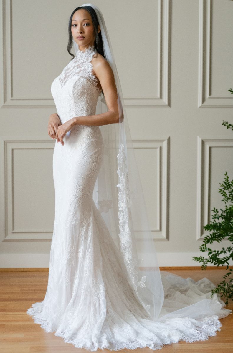 Bride wearing long lace veil 