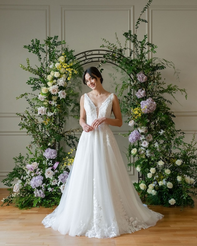This is a V-neck A-line wedding gown with 3D floral appliqués.
