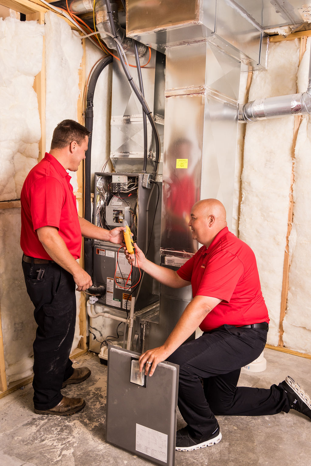 Prudential Heating & Conditioning technicians performing ductless mini split installation in Louisville KY HVAC system.