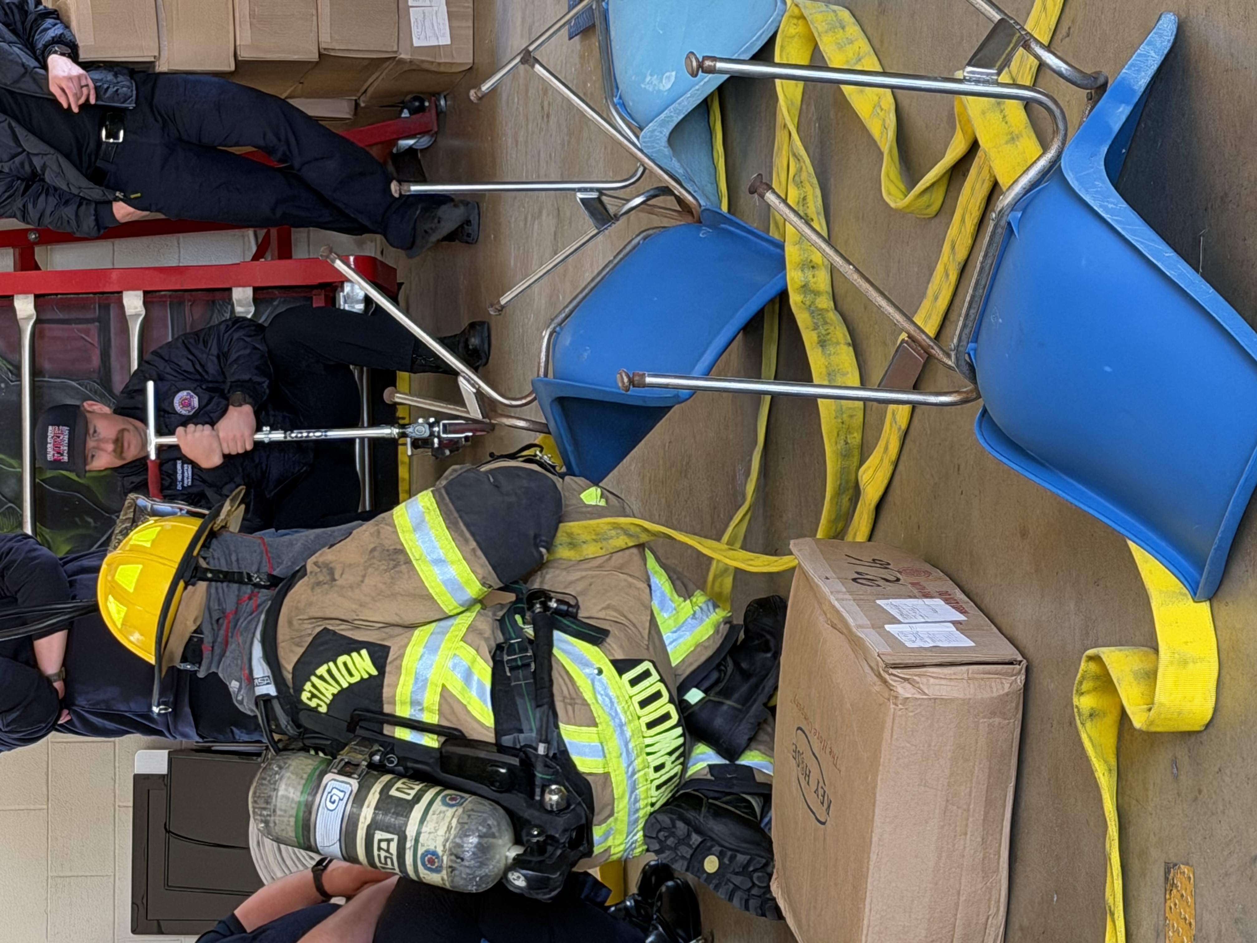 Two firefighters win gear and covered win foam