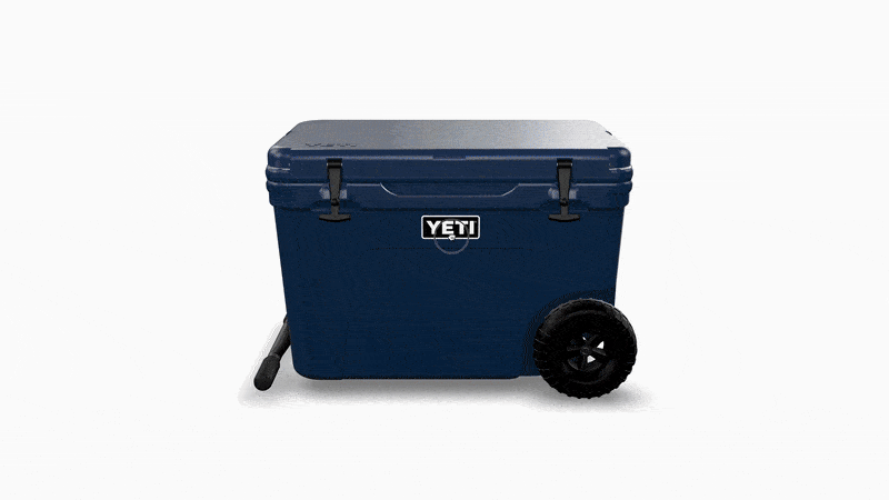 Dark blue YETI cooler with wheels and a telescoping handle rotating to show different angles.