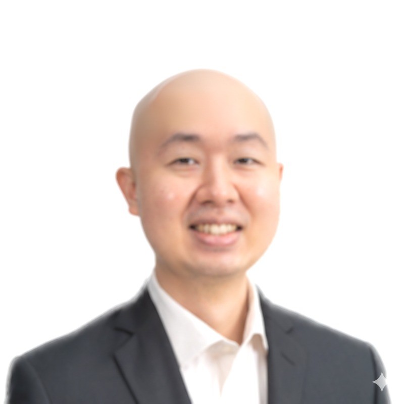 Smiling bald man wearing a white shirt and black blazer against a white background.