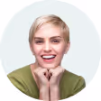 A woman with blonde hair and a green shirt smiling.