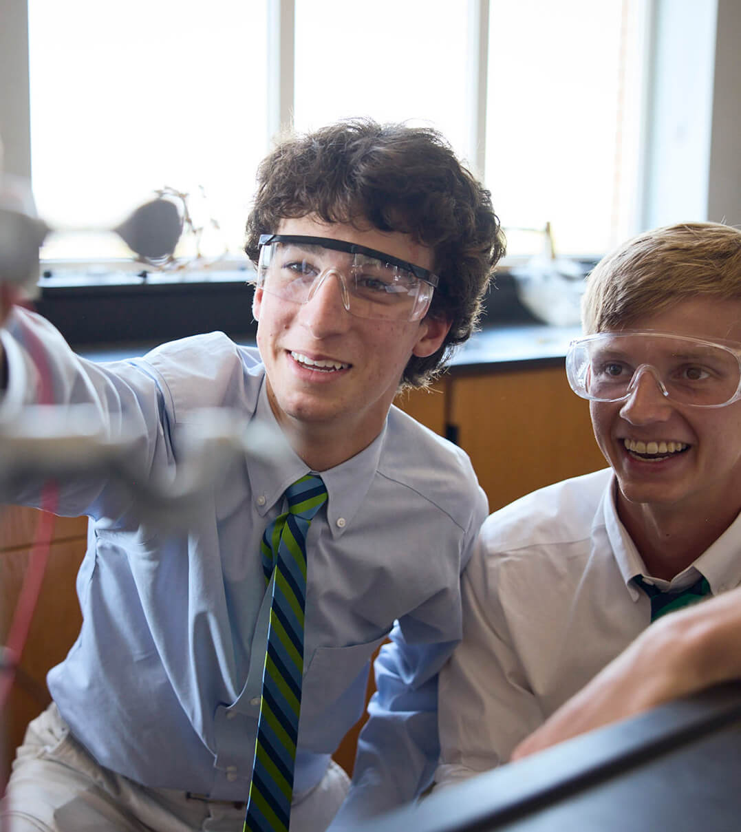 McCallie students wearing protective eyewear and conducting a science experiment.