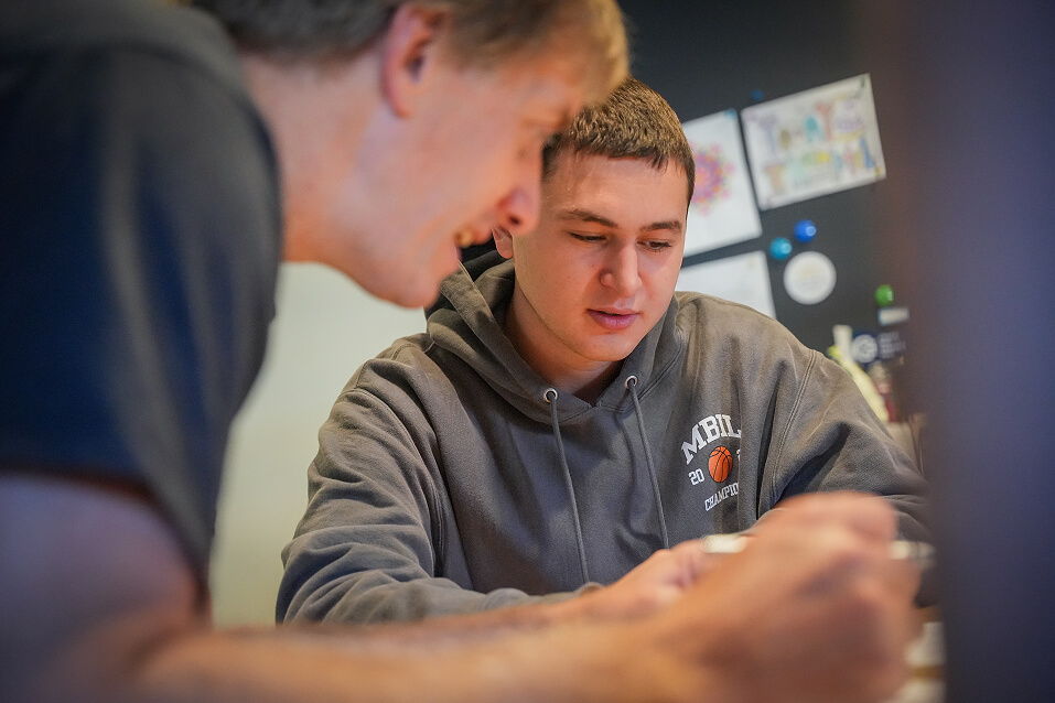 A Chapel Hill-Chauncy Hall teacher helps a student with an assignment.