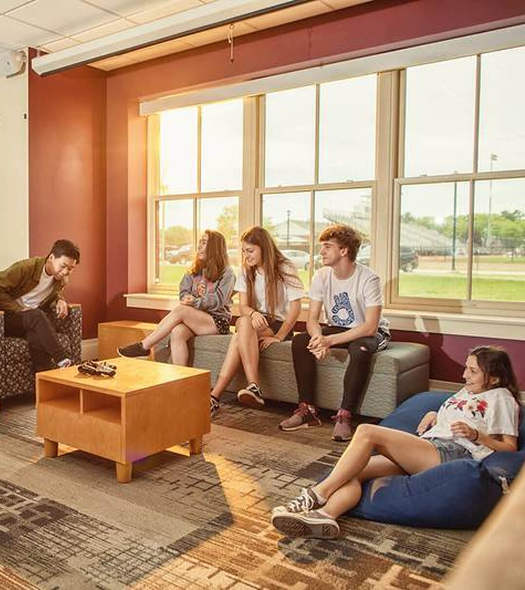 Thornton Academy students hanging out and talking in a dorm common area.