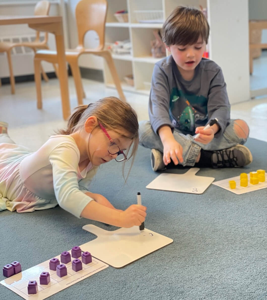 Two Long Ridge students practice counting using blocks.
