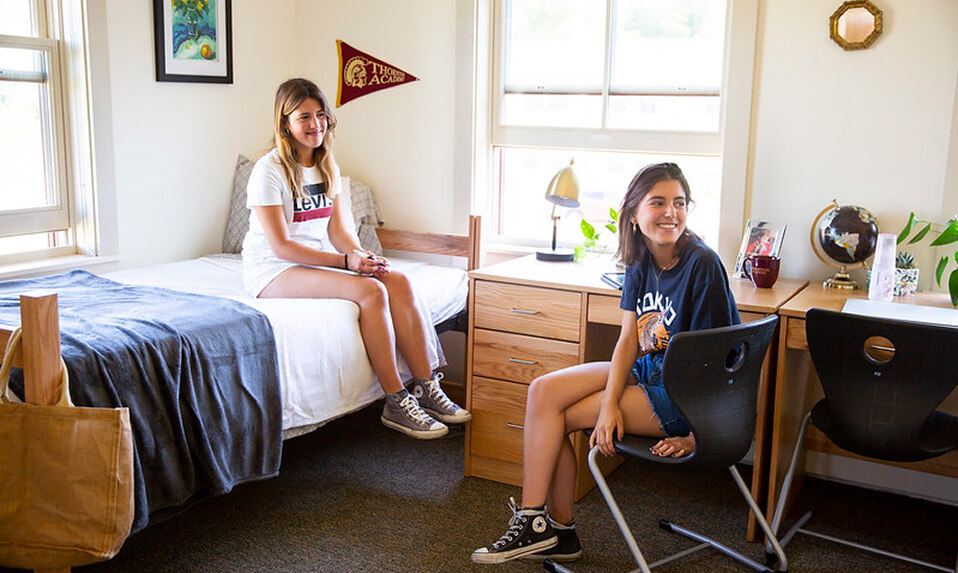 Two Thornton Academy boarding students sitting in their dorm room.