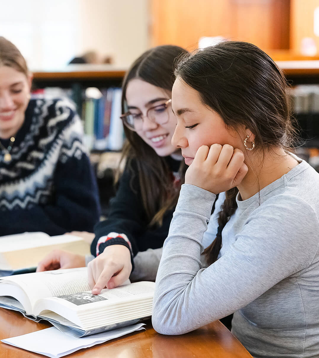 Miss Hall's School students studying together in the library.