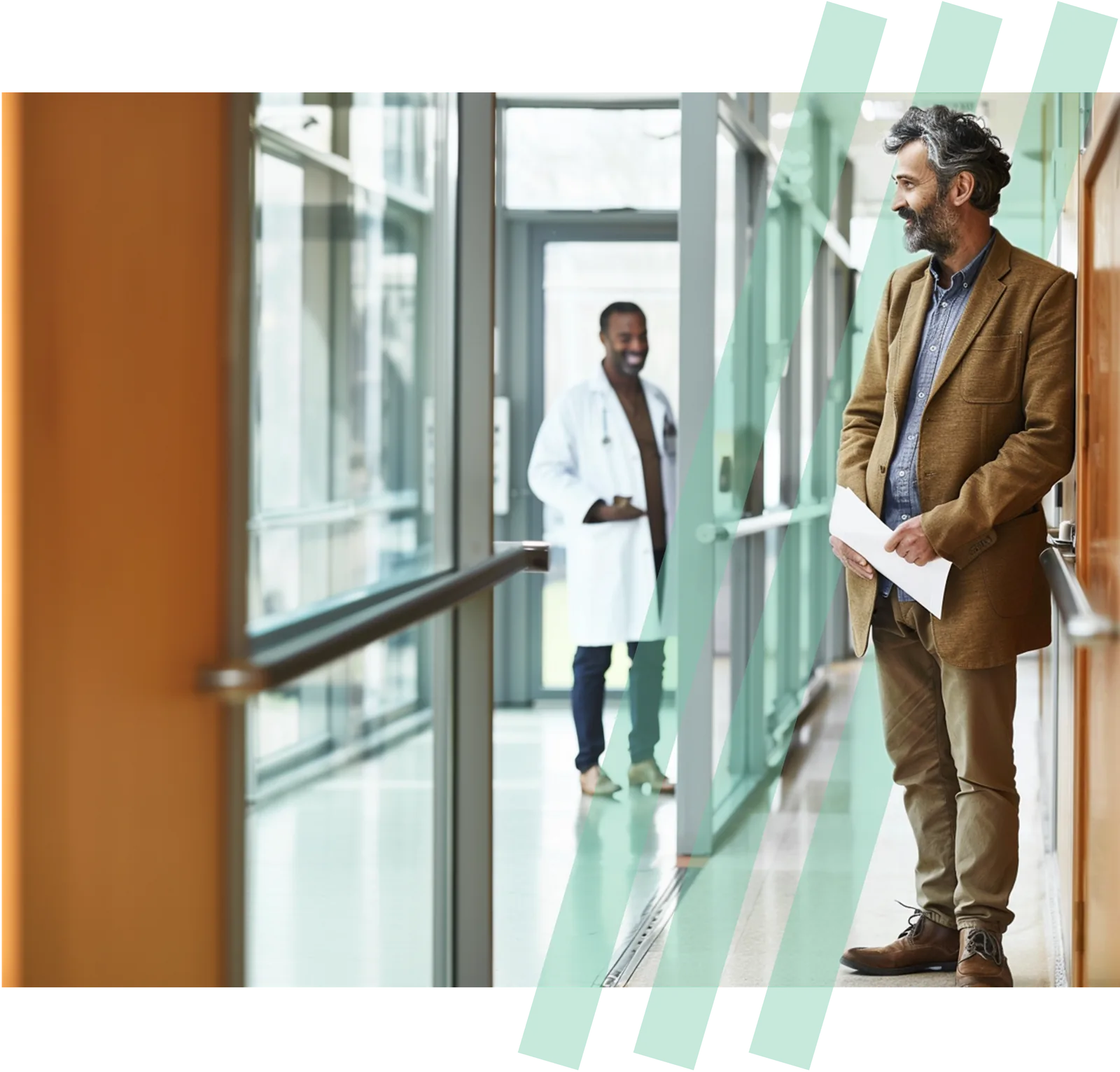 A man waits in a hospital hallway as a physician approaches