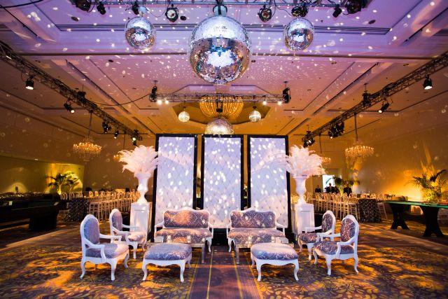 Wedding lounge with feathers under mirror balls