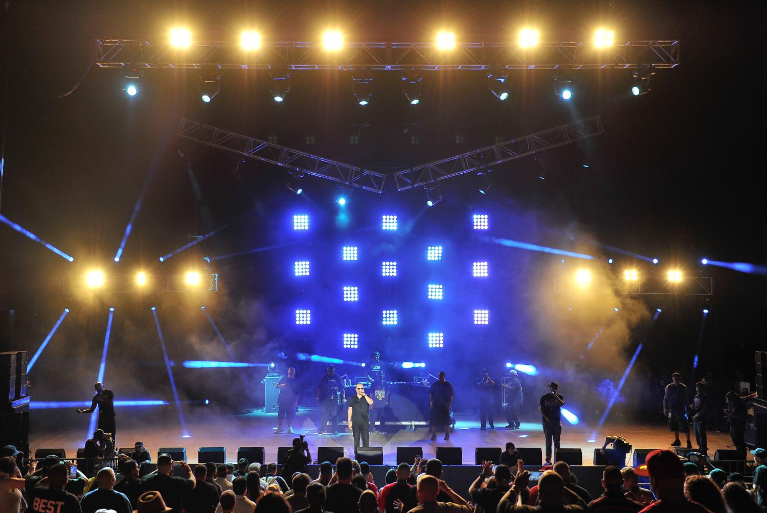 Concert stage with line arrays and blue beams