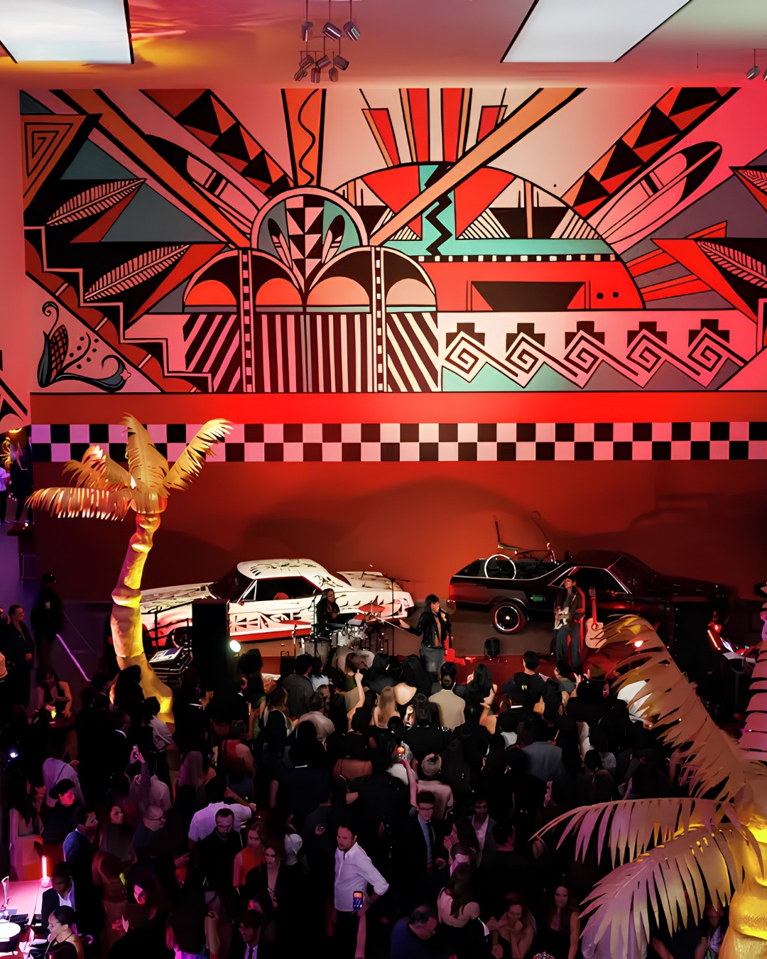 Art Deco after-party room with custom murals and classic cars at the de Young Annual Gala